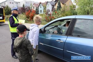 Dzieci z policjantką przy samochodzie