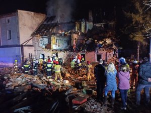 Miejsce katastrofy budowlanej. W tle strażacy, policjanci, służby