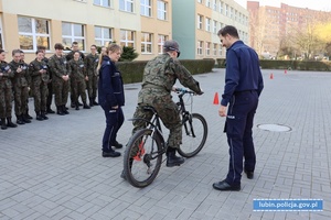 Uczniowie z nałożonymi na oczy alkogoglami pokonuj a tor przeszkód na rowerze