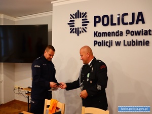 Policjant odbiera podziękowania od Prezesa Ochotniczej Straży Pożarnej