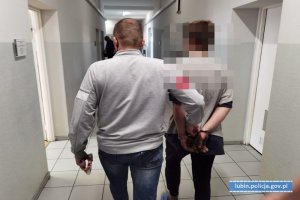 Policjant prowadzi zatrzymanego